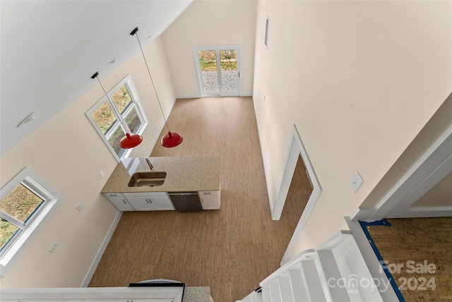 hallway featuring wood-type flooring and high vaulted ceiling