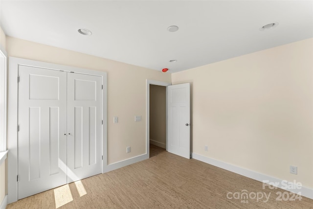 unfurnished bedroom with carpet flooring and a closet