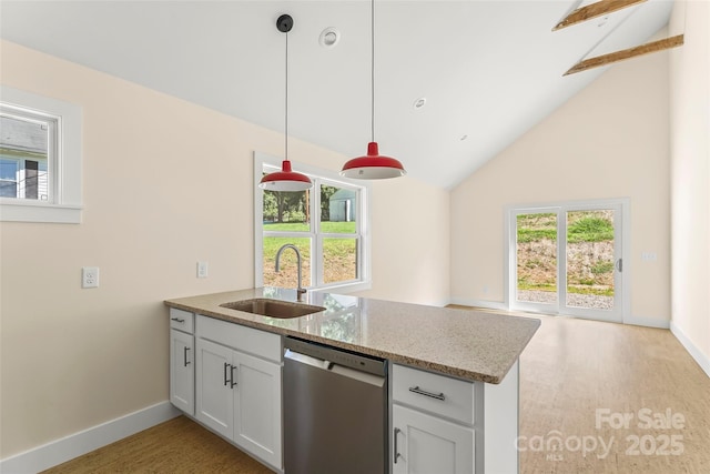 kitchen with a wealth of natural light, a sink, a peninsula, and stainless steel dishwasher