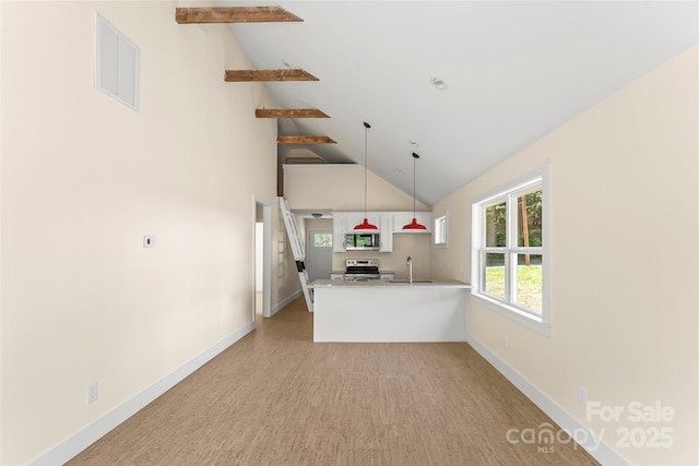 kitchen with open shelves, light countertops, visible vents, appliances with stainless steel finishes, and a peninsula