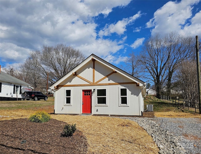 view of front of property with fence and central air condition unit