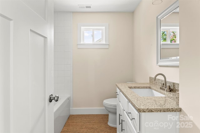 full bath with toilet, wood finished floors, visible vents, vanity, and baseboards