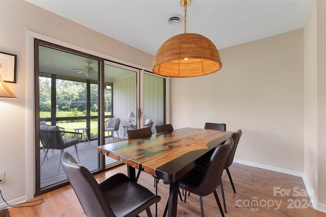 dining space with hardwood / wood-style flooring and ceiling fan