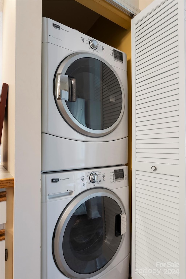 washroom featuring stacked washer and dryer