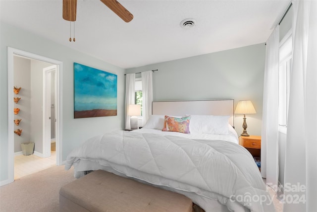 bedroom featuring light colored carpet and ceiling fan