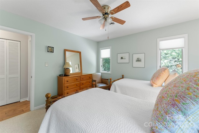 bedroom with carpet flooring, a closet, and ceiling fan