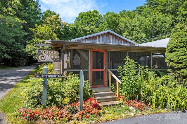 bungalow-style home with a sunroom