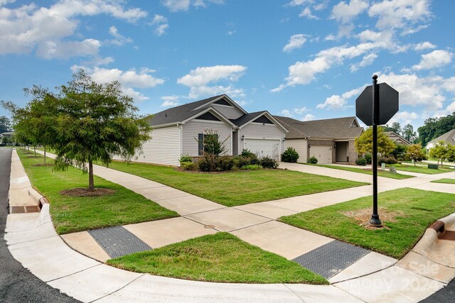 view of front facade with a garage and a front lawn