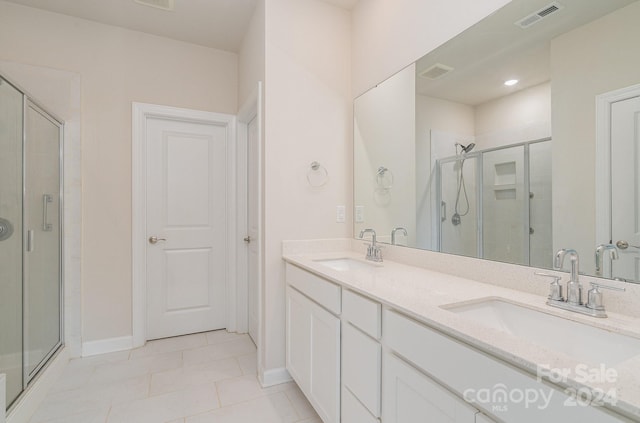 bathroom with vanity, tile patterned flooring, and a shower with door