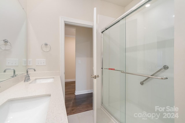 bathroom featuring an enclosed shower, vanity, and tile patterned flooring