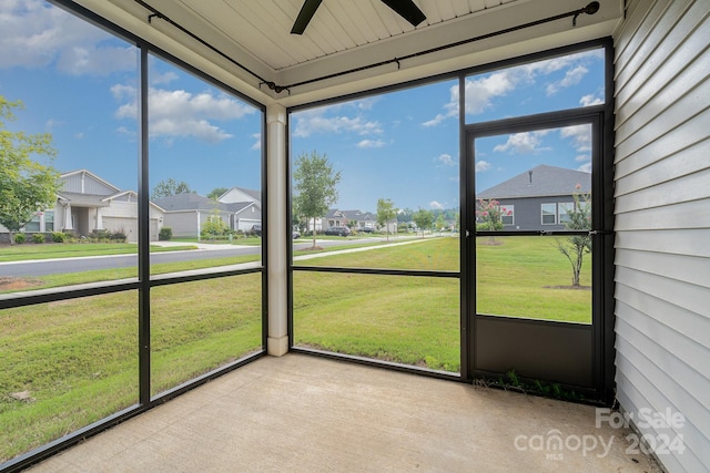 unfurnished sunroom featuring ceiling fan