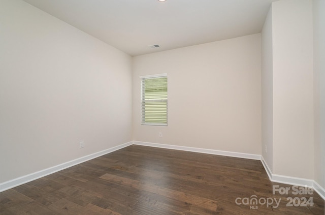 spare room with dark hardwood / wood-style flooring