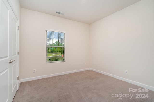 empty room featuring light colored carpet