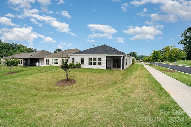 back of property featuring a lawn