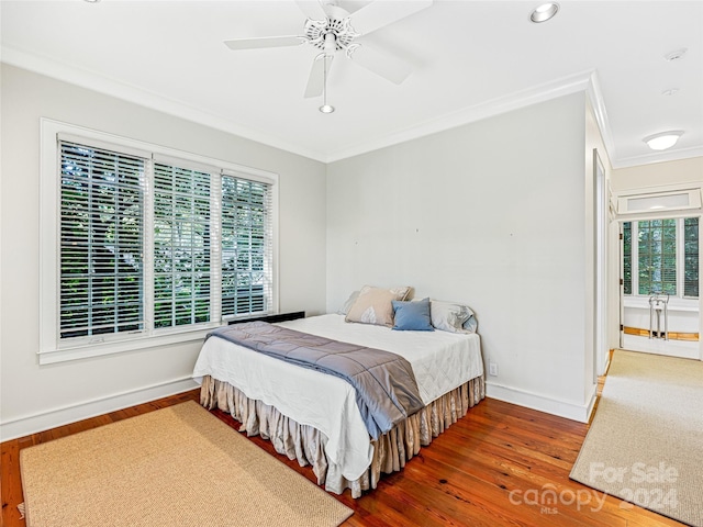 bedroom with ceiling fan, wood-type flooring, and ornamental molding