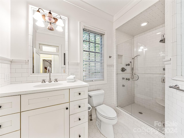 bathroom with a shower with door, tile patterned flooring, toilet, ornamental molding, and tile walls