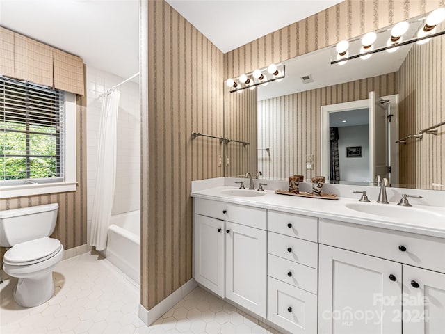 full bathroom featuring tile patterned flooring, vanity, toilet, and shower / bath combo with shower curtain