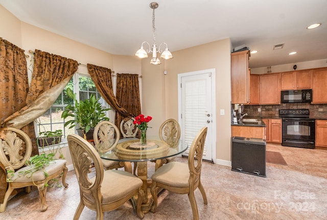 dining area with an inviting chandelier