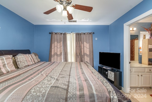 bedroom featuring ceiling fan, sink, and connected bathroom