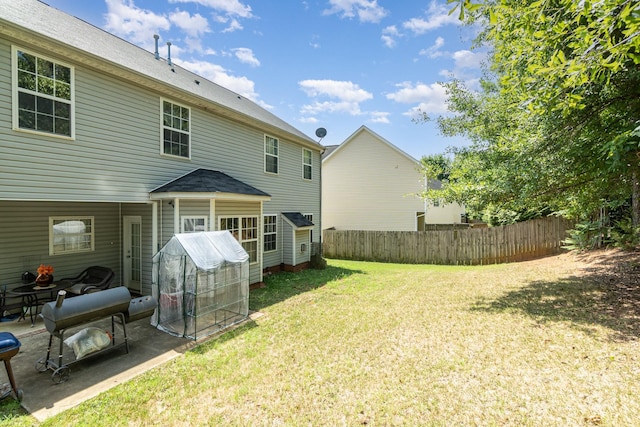 rear view of property with a lawn