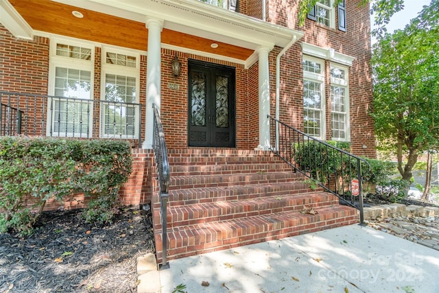 view of exterior entry featuring a porch