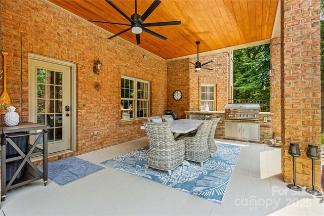 view of patio with ceiling fan, area for grilling, and grilling area