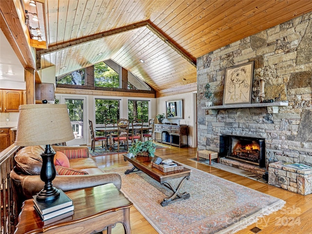 living room with a stone fireplace, high vaulted ceiling, wood ceiling, and light hardwood / wood-style floors