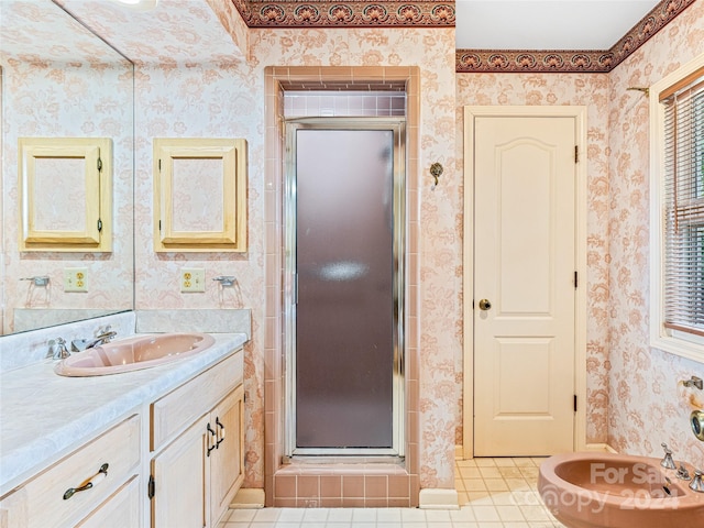 bathroom with tile patterned flooring, vanity, and walk in shower