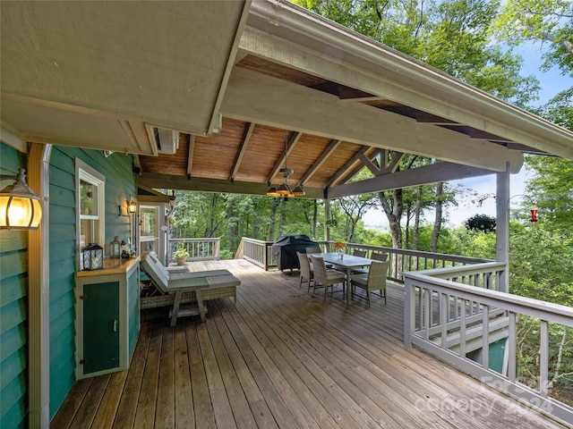 wooden deck featuring ceiling fan and area for grilling