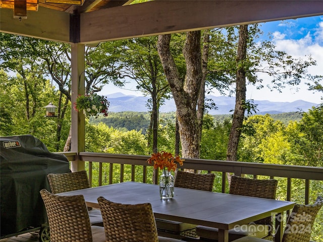 wooden terrace with a mountain view and area for grilling