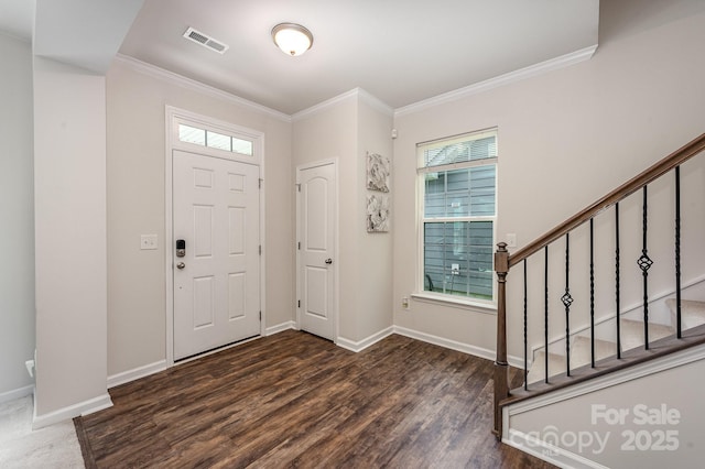 foyer entrance with crown molding and dark hardwood / wood-style flooring