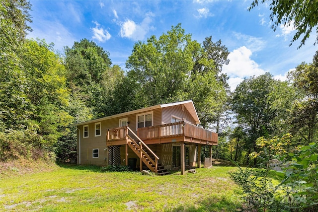 view of front of house with stairway, a wooden deck, and a front yard