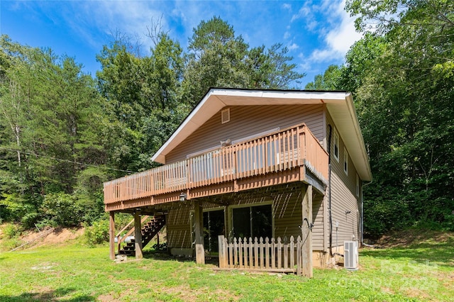 rear view of house featuring a yard, central AC, a wooden deck, and stairway