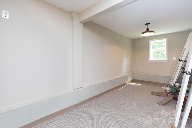 exercise room featuring carpet and baseboards