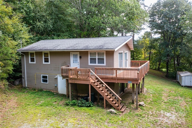 view of front of house featuring an outbuilding, a deck, a shed, a front yard, and stairs