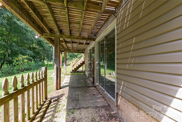 view of patio / terrace with stairs and fence