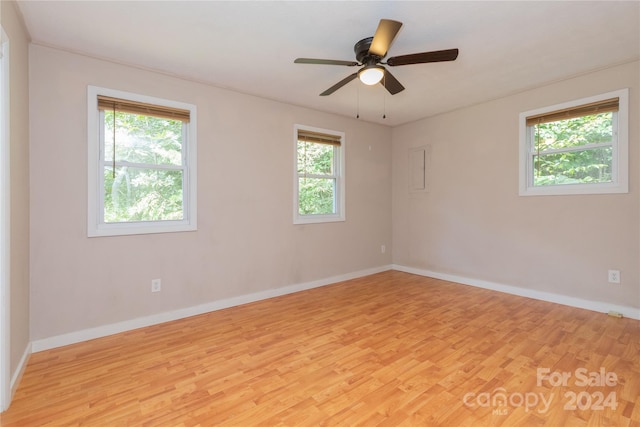 spare room with a ceiling fan, baseboards, and light wood finished floors