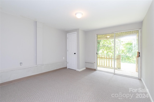 unfurnished room with baseboards and carpet