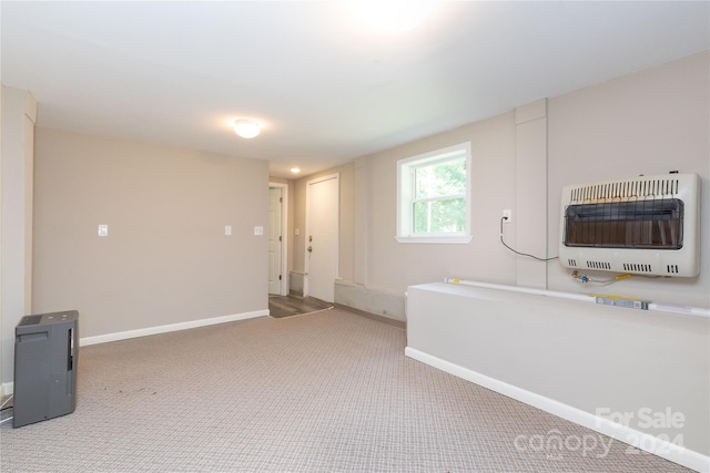 interior space with baseboards, heating unit, and carpet floors