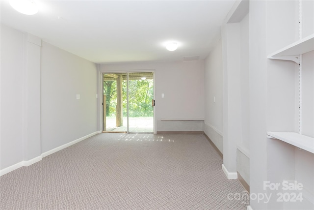 empty room with light colored carpet and baseboards