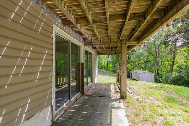 view of patio with a storage shed