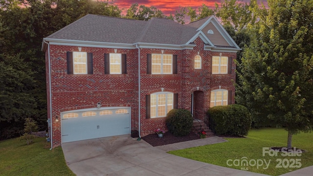 view of front of house with a garage and a yard