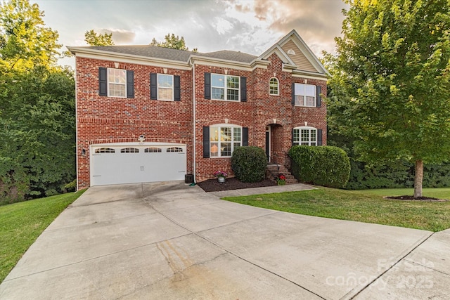 view of front of property with a lawn and a garage