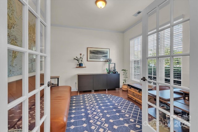 office area with french doors, crown molding, and dark wood-type flooring