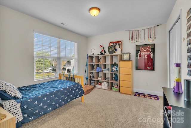 carpeted bedroom featuring a closet