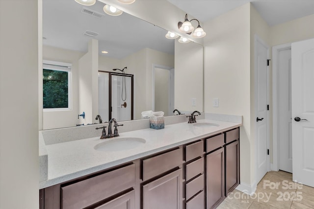 bathroom with tile patterned floors, vanity, and walk in shower