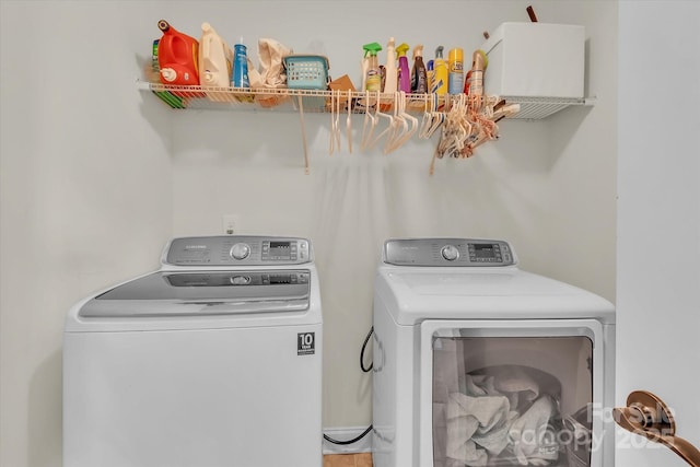 clothes washing area with washer and dryer