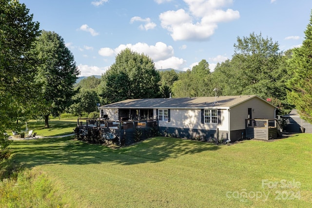 back of property with a lawn