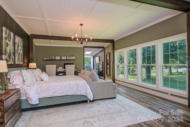 bedroom with hardwood / wood-style floors, wood ceiling, and an inviting chandelier