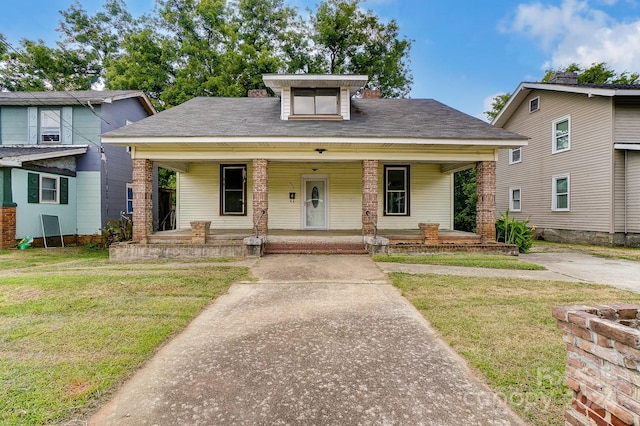 view of front of house with covered porch and a front lawn